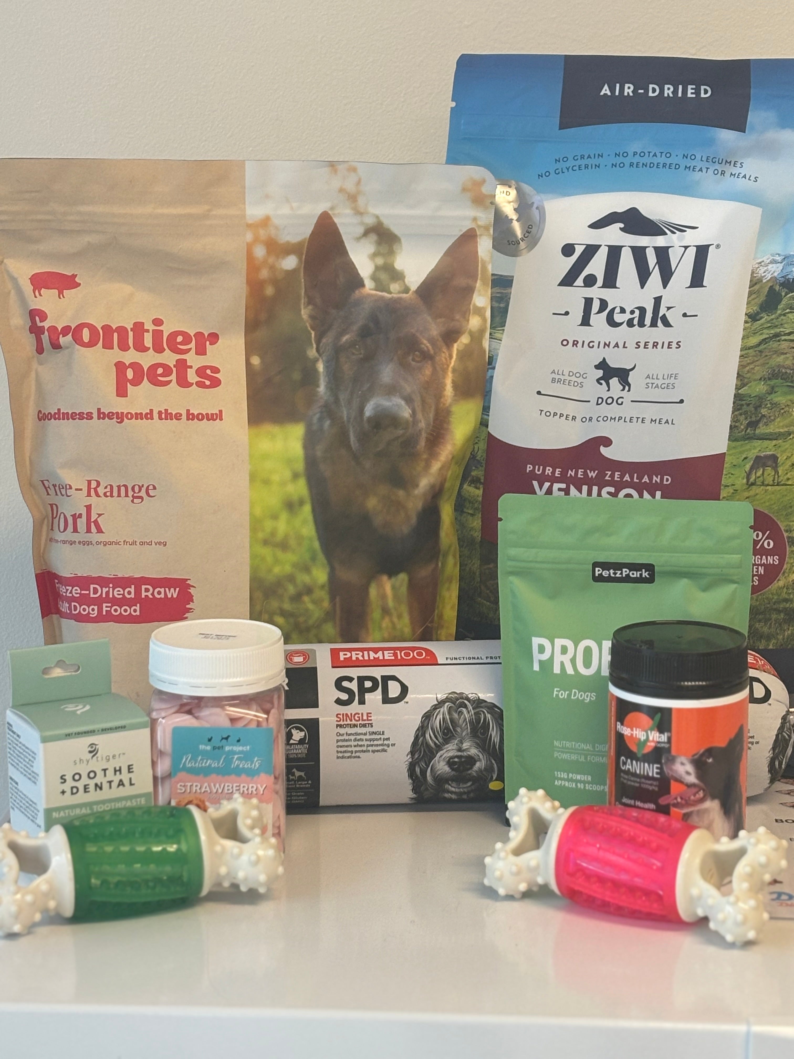 Photo containing packs of dog food, care tools and toys